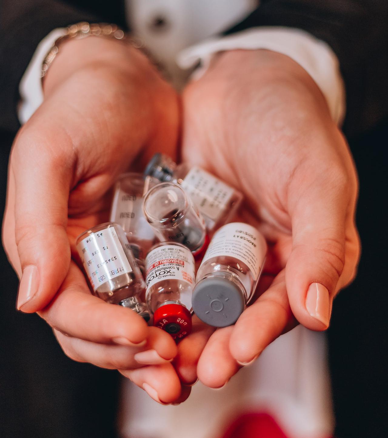 Woman holding pharmaceutical bottles