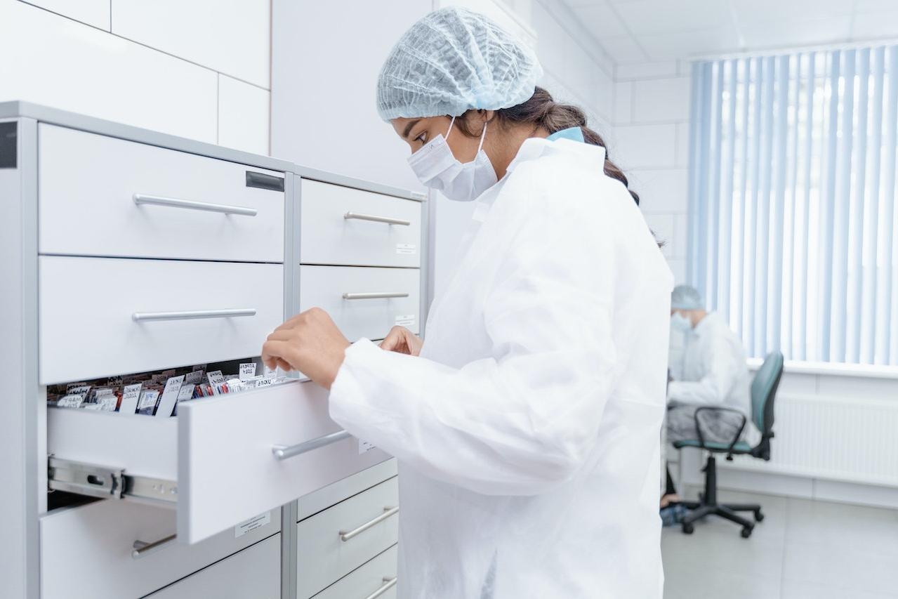 Medical Professional looking at Archives on a Drawer