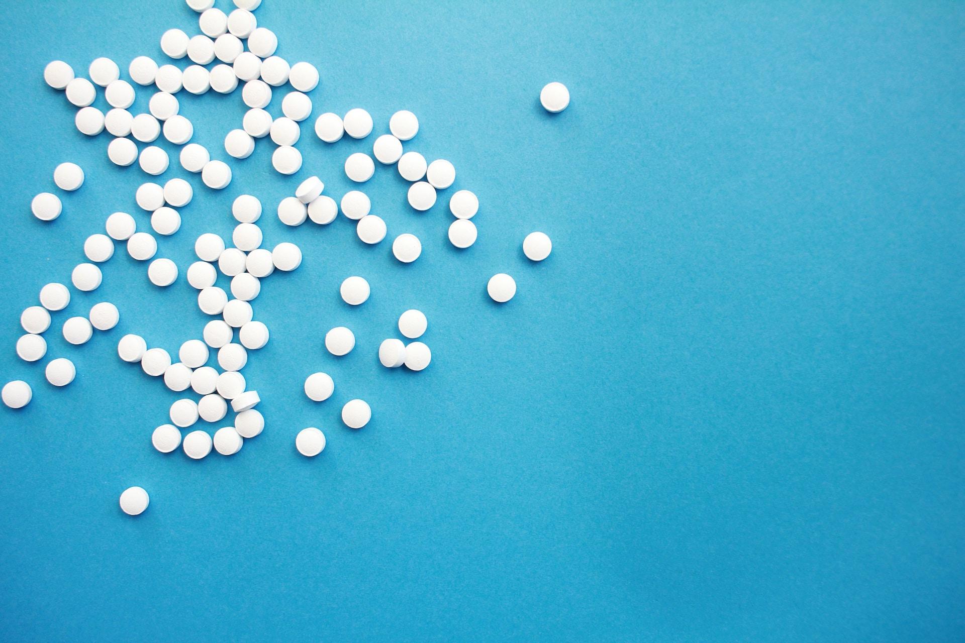 White pills on a blue background