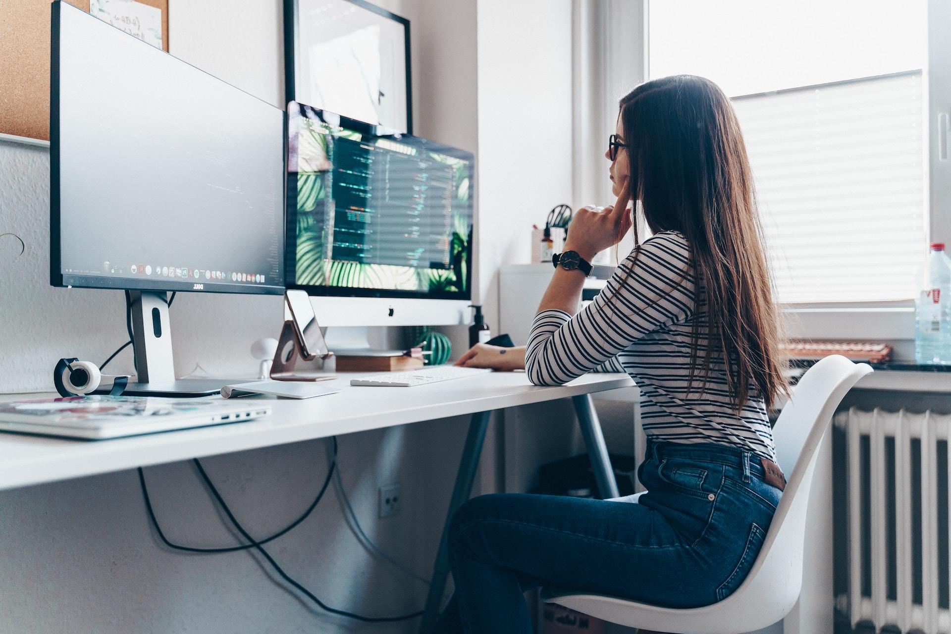 girl using desktop computer in room