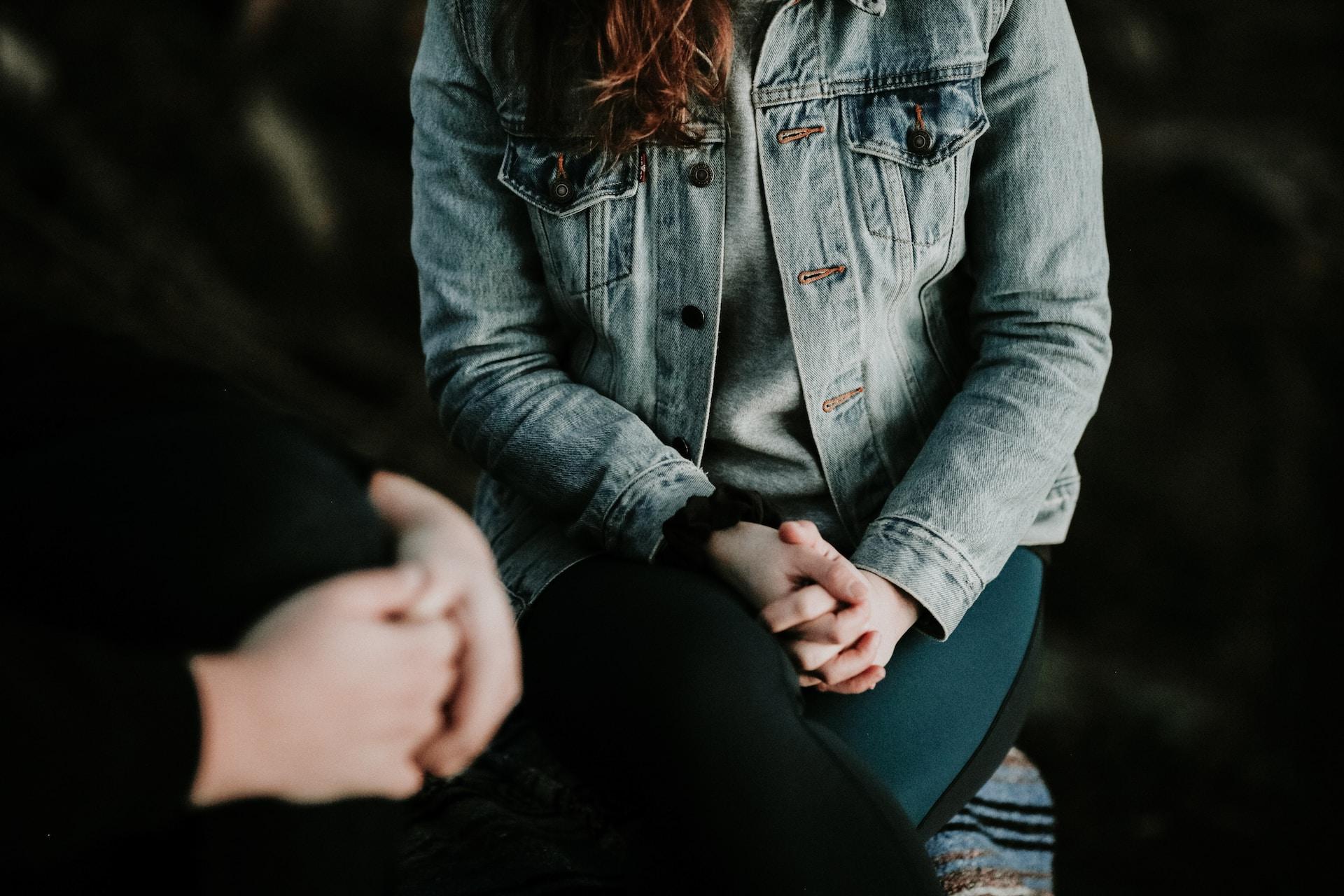 woman with arms crossed over her legs