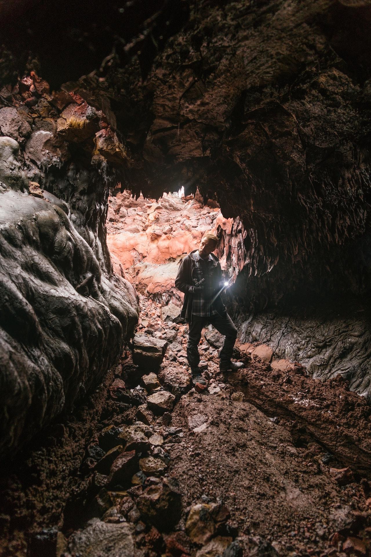 Man with Light Exploring Cave