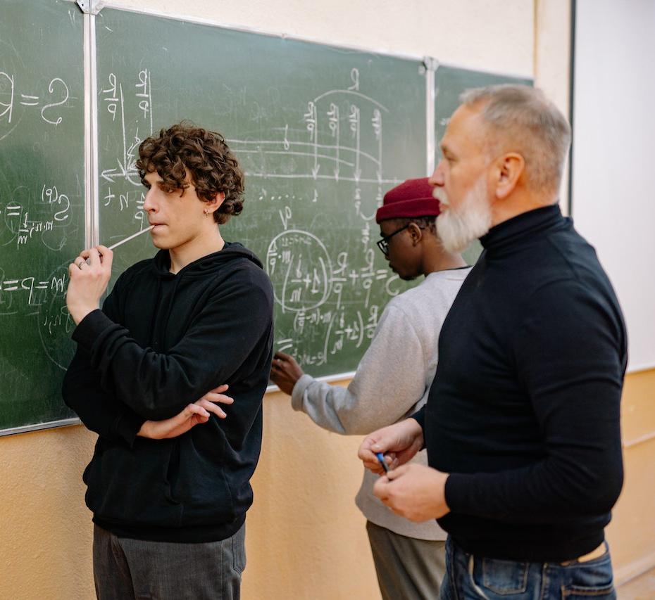 Students working on math problems with their professor